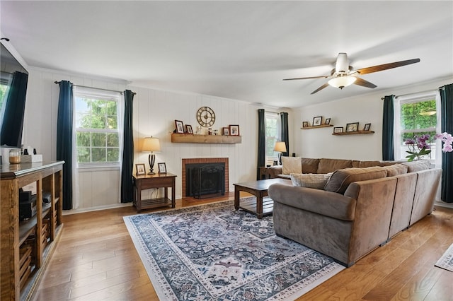 240 Patton Dr, Moon/Crescent Twp, PA 15108 - living area with healthy amount of natural light, ceiling fan, light wood-style floors, and a brick fireplace