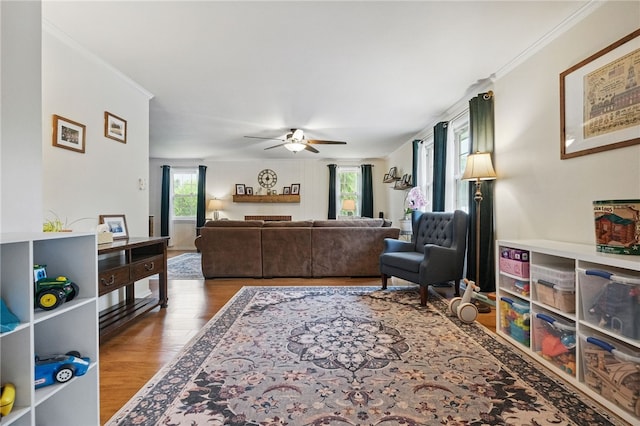 240 Patton Dr, Moon/Crescent Twp, PA 15108 - living area featuring healthy amount of natural light, wood finished floors, a ceiling fan, and crown molding