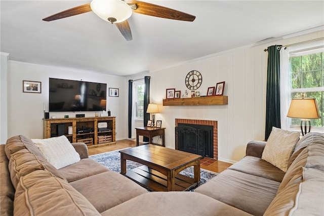 240 Patton Dr, Moon/Crescent Twp, PA 15108 - living room with plenty of natural light, a brick fireplace, ceiling fan, wood finished floors, and crown molding