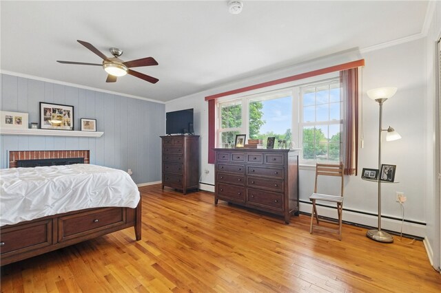240 Patton Dr, Moon/Crescent Twp, PA 15108 - bedroom with ornamental molding, light wood-style flooring, baseboards, a brick fireplace, and a baseboard radiator