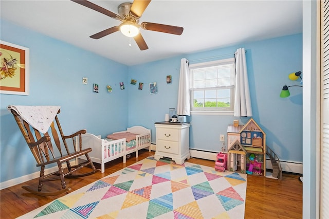 240 Patton Dr, Moon/Crescent Twp, PA 15108 - bedroom featuring wood finished floors, a baseboard heating unit, and baseboards