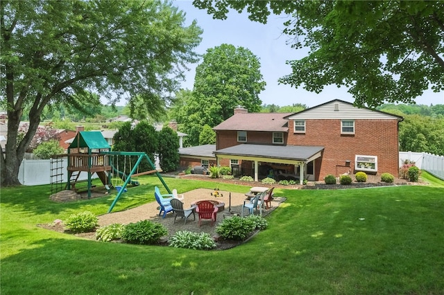 240 Patton Dr, Moon/Crescent Twp, PA 15108 - rear view of house featuring a playground, a patio area, an outdoor fire pit, a chimney, and brick siding