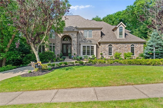 623 Oswego Dr, Adams Twp, PA 15044 - french country home with stone siding, a front yard, and french doors