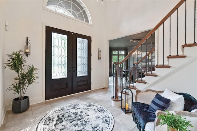 623 Oswego Dr, Adams Twp, PA 15044 - entrance foyer featuring french doors, stairway, baseboards, tile patterned floors, and a towering ceiling