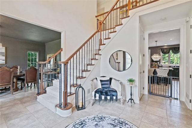 623 Oswego Dr, Adams Twp, PA 15044 - stairway with a chandelier, crown molding, tile patterned floors, and baseboards
