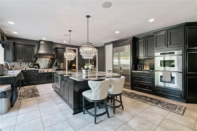623 Oswego Dr, Adams Twp, PA 15044 - kitchen with appliances with stainless steel finishes, custom range hood, dark cabinets, a chandelier, and decorative backsplash