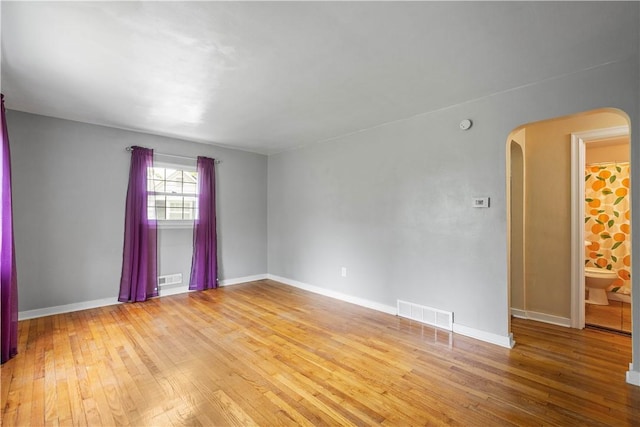 1853 Montour St, Coraopolis, PA 15108 - spare room featuring arched walkways, light wood-style flooring, and baseboards