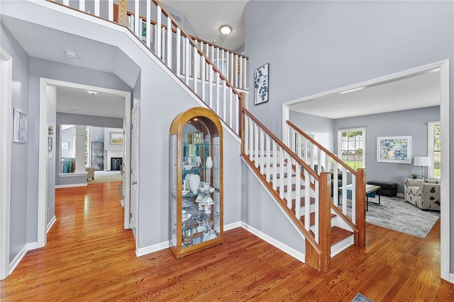 232 Crosswinds Ct, North Fayette, PA 15108 - staircase featuring wood finished floors, baseboards, and a high ceiling
