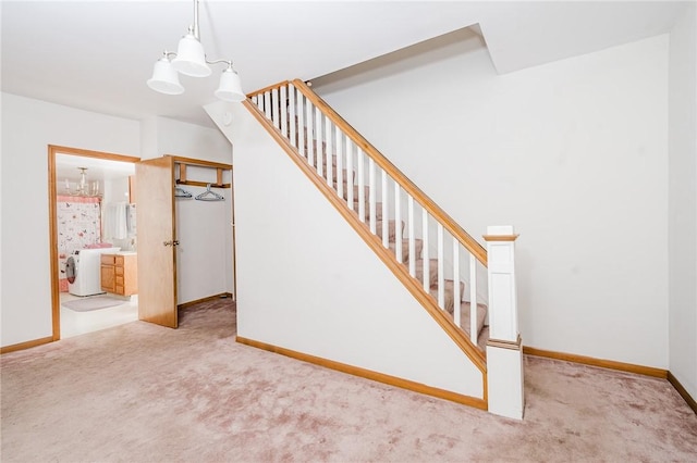 38 Locust St, Center Twp/Homer Cty, PA 15731 - stairway featuring carpet floors, baseboards, separate washer and dryer, and a chandelier