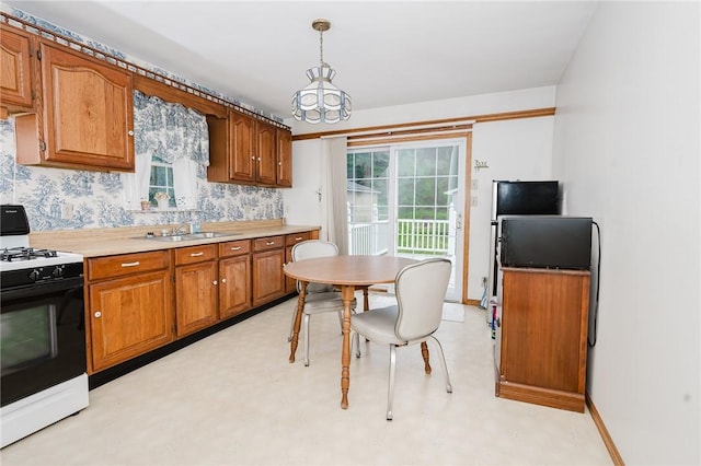 38 Locust St, Center Twp/Homer Cty, PA 15731 - kitchen with gas stove, brown cabinetry, a sink, and light countertops