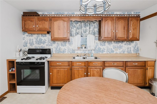 38 Locust St, Center Twp/Homer Cty, PA 15731 - kitchen featuring black gas range oven, a sink, and brown cabinets