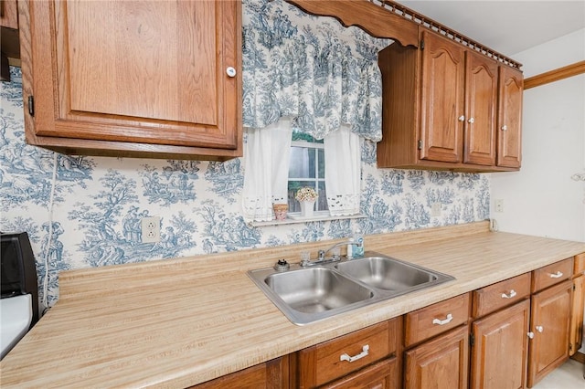 38 Locust St, Center Twp/Homer Cty, PA 15731 - kitchen featuring a sink, wallpapered walls, light countertops, and brown cabinets