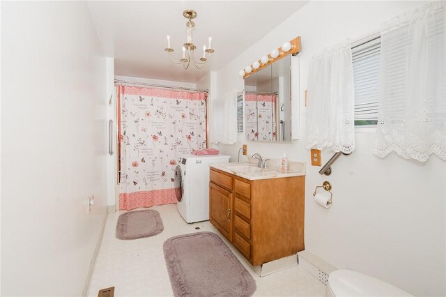 38 Locust St, Center Twp/Homer Cty, PA 15731 - bathroom with washer and clothes dryer, a chandelier, vanity, toilet, and tile patterned floors