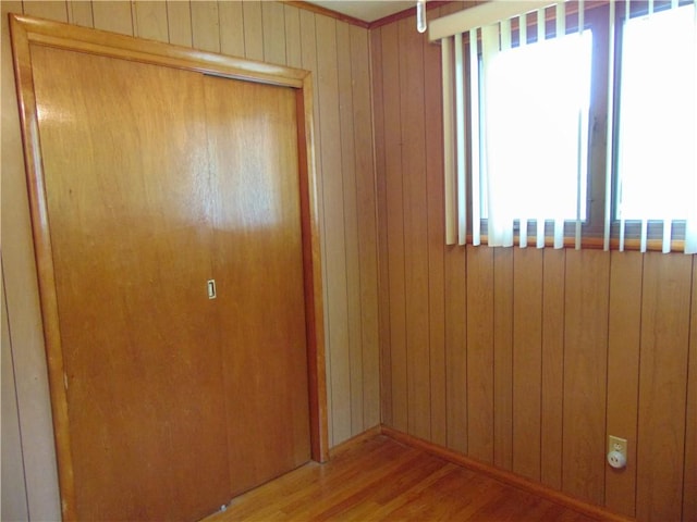 822 Fayette City Rd, Washington Twp, PA 15438 - unfurnished bedroom featuring multiple windows, a closet, wood finished floors, and wood walls