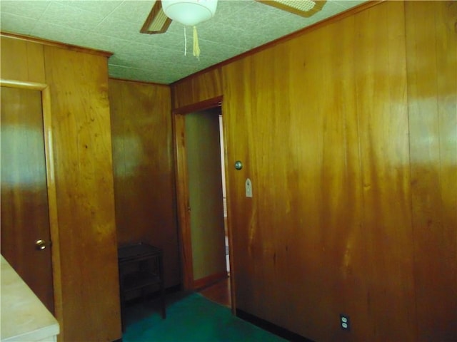 822 Fayette City Rd, Washington Twp, PA 15438 - spare room with wood walls, ceiling fan, and a wood stove