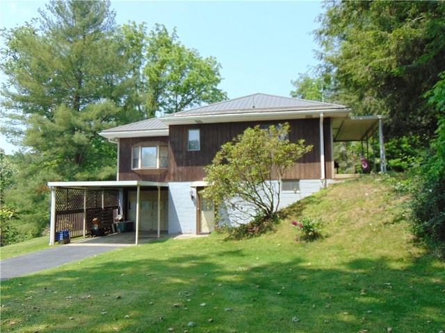 822 Fayette City Rd, Washington Twp, PA 15438 - rear view of house featuring driveway, a lawn, metal roof, a standing seam roof, and an attached carport