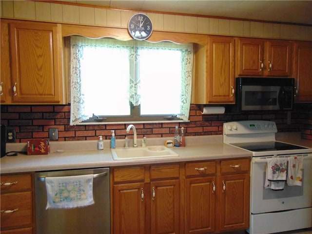 822 Fayette City Rd, Washington Twp, PA 15438 - kitchen featuring white range with electric stovetop, black microwave, dishwasher, a sink, and brown cabinetry