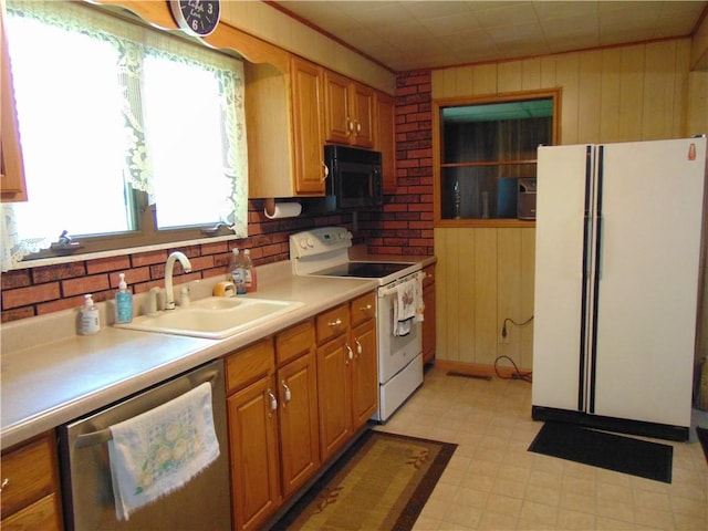 822 Fayette City Rd, Washington Twp, PA 15438 - kitchen with white appliances, a sink, wooden walls, light flooring, and light countertops