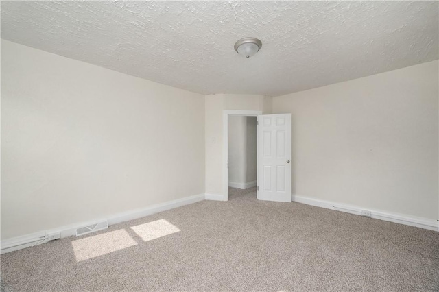 330 N Elm St, City Of But Nw, PA 16001 - empty room featuring light colored carpet, baseboards, and a textured ceiling