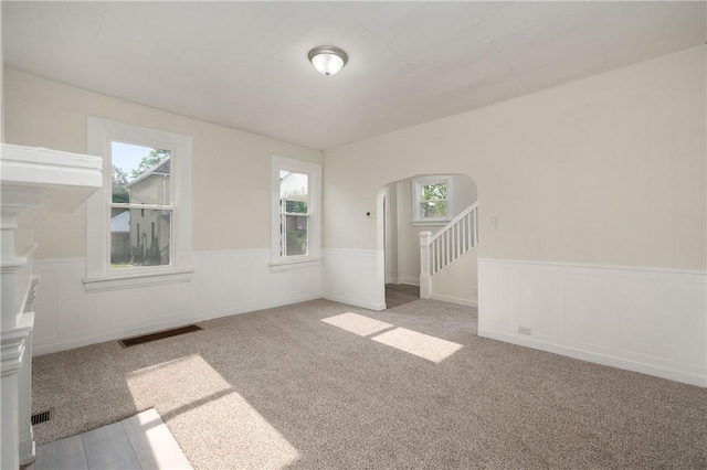 330 N Elm St, City Of But Nw, PA 16001 - spare room with arched walkways, wainscoting, carpet flooring, and a decorative wall
