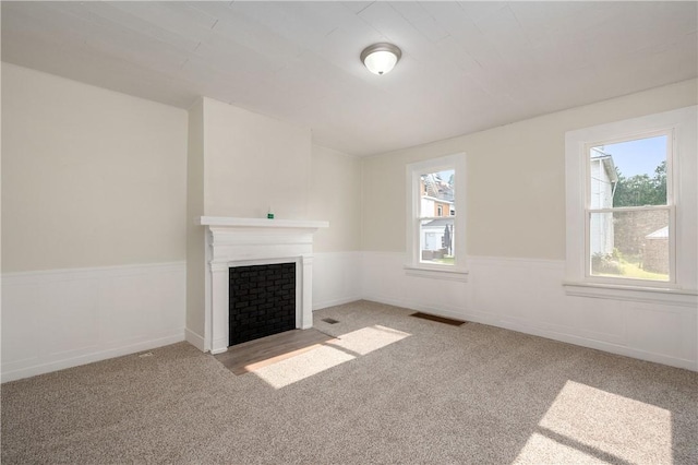 330 N Elm St, City Of But Nw, PA 16001 - unfurnished living room with a wainscoted wall, carpet floors, and a fireplace with flush hearth