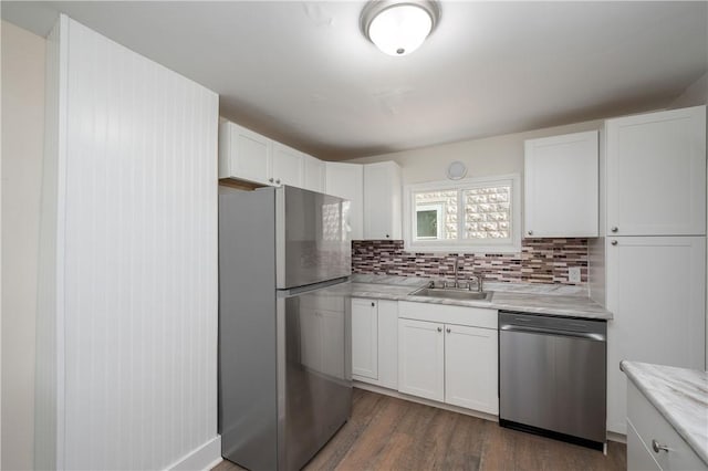 330 N Elm St, City Of But Nw, PA 16001 - kitchen with appliances with stainless steel finishes, a sink, white cabinets, backsplash, and wood finished floors