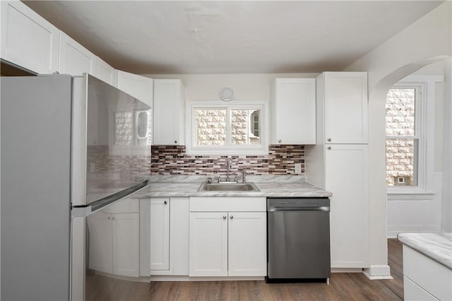 330 N Elm St, City Of But Nw, PA 16001 - kitchen featuring appliances with stainless steel finishes, a sink, white cabinetry, wood finished floors, and backsplash