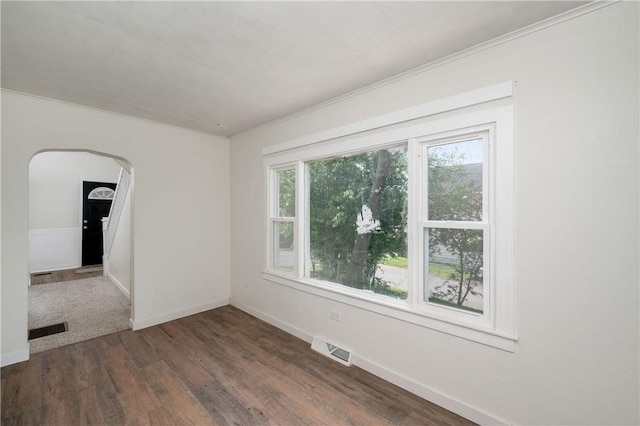 330 N Elm St, City Of But Nw, PA 16001 - empty room with wood finished floors, ornamental molding, baseboards, and arched walkways