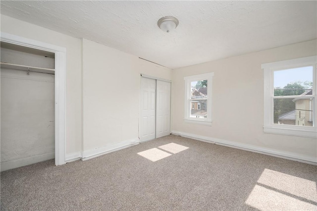 330 N Elm St, City Of But Nw, PA 16001 - unfurnished bedroom featuring multiple closets, carpet floors, and baseboards