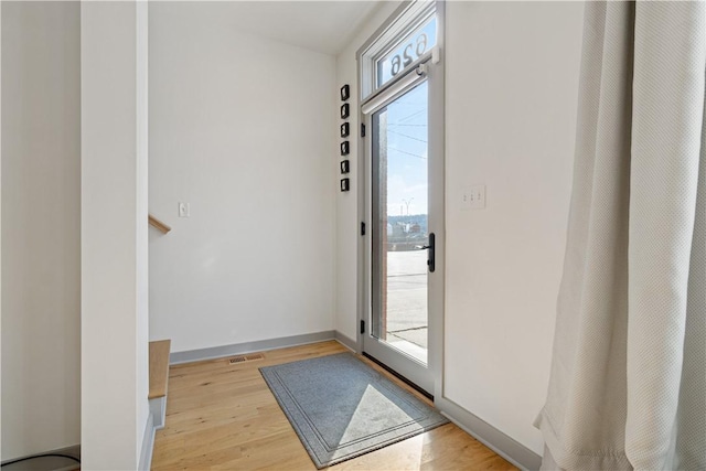 626 Suismon St, East Allegheny, PA 15212 - doorway to outside with light wood finished floors, healthy amount of natural light, and baseboards