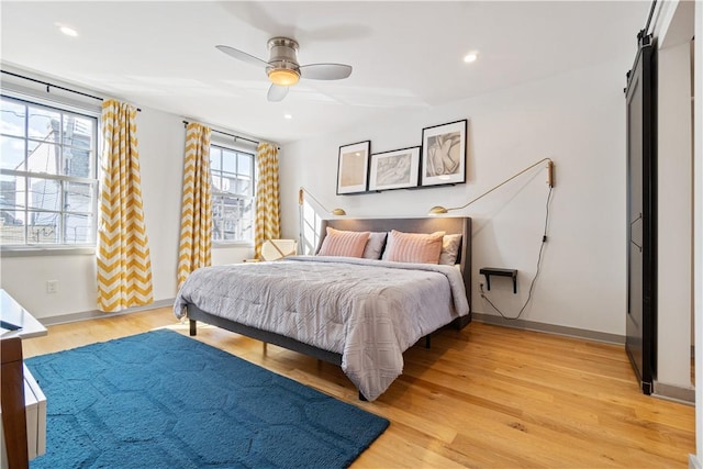 626 Suismon St, East Allegheny, PA 15212 - bedroom with light wood-type flooring, recessed lighting, baseboards, a barn door, and a ceiling fan