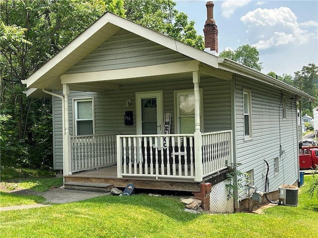 796 S Gray Ave, Collier Twp, PA 15017 - view of front of home featuring a porch, central AC, a front yard, and a chimney