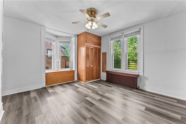 222 Marshall Ave, Observatory Hill, PA 15214 - unfurnished living room featuring radiator, ceiling fan, wood finished floors, and baseboards