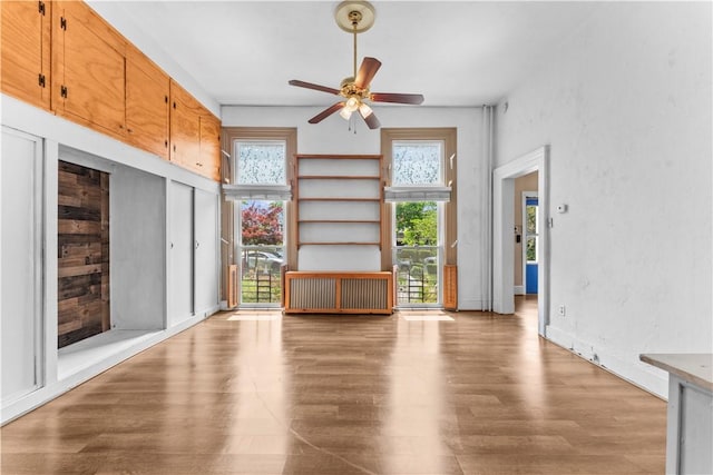 222 Marshall Ave, Observatory Hill, PA 15214 - unfurnished living room featuring a ceiling fan, wood finished floors, and radiator heating unit