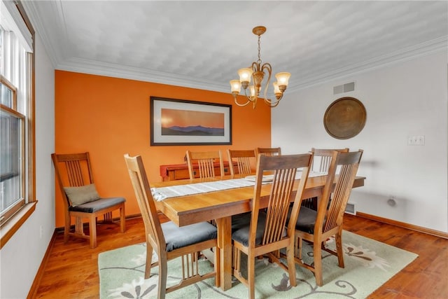 106 Shawnee Dr, Center Twp But, PA 16001 - dining room featuring a chandelier, plenty of natural light, crown molding, and wood finished floors