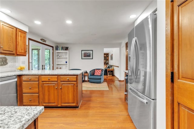 106 Shawnee Dr, Center Twp But, PA 16001 - kitchen featuring stainless steel appliances, brown cabinetry, a peninsula, light wood-style floors, and recessed lighting