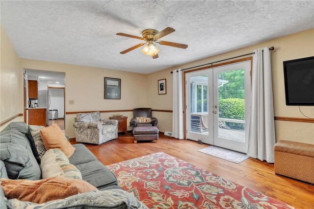 106 Shawnee Dr, Center Twp But, PA 16001 - living area featuring french doors, light wood finished floors, a ceiling fan, and a textured ceiling