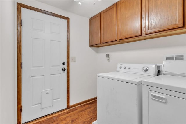 106 Shawnee Dr, Center Twp But, PA 16001 - laundry area featuring separate washer and dryer, cabinet space, wood finished floors, and baseboards