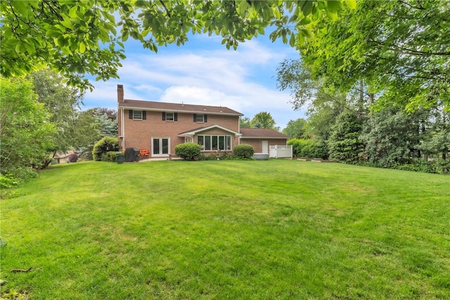 106 Shawnee Dr, Center Twp But, PA 16001 - rear view of house with a chimney, a yard, and brick siding