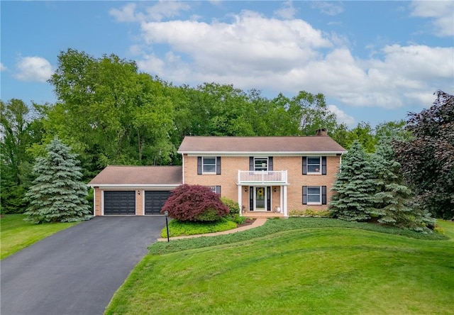 106 Shawnee Dr, Center Twp But, PA 16001 - view of front of house featuring asphalt driveway, a balcony, an attached garage, a front lawn, and brick siding
