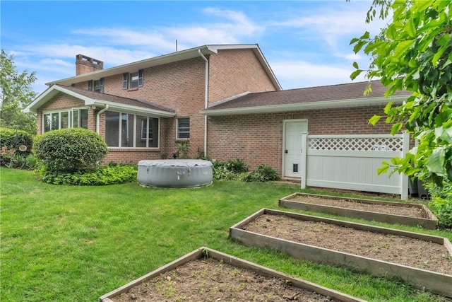 106 Shawnee Dr, Center Twp But, PA 16001 - rear view of house with a vegetable garden, brick siding, a chimney, and a yard