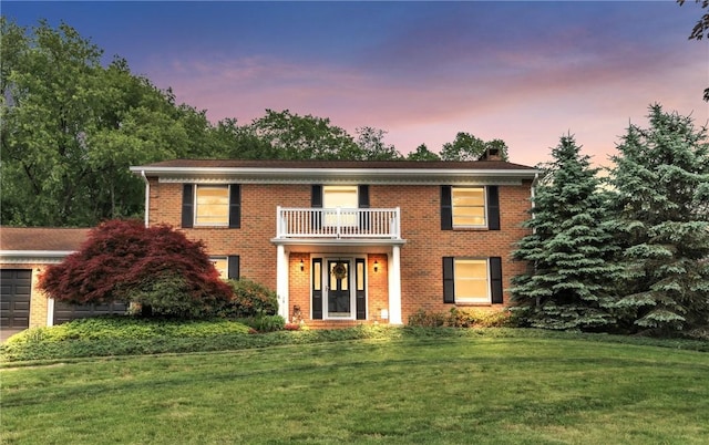 106 Shawnee Dr, Center Twp But, PA 16001 - georgian-style home featuring a balcony, a front yard, brick siding, a chimney, and a garage