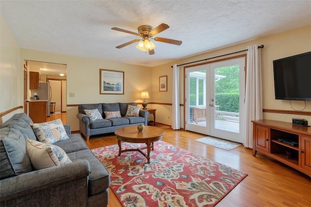 106 Shawnee Dr, Center Twp, PA 16001 - living area featuring french doors, light wood-style floors, a ceiling fan, and a textured ceiling