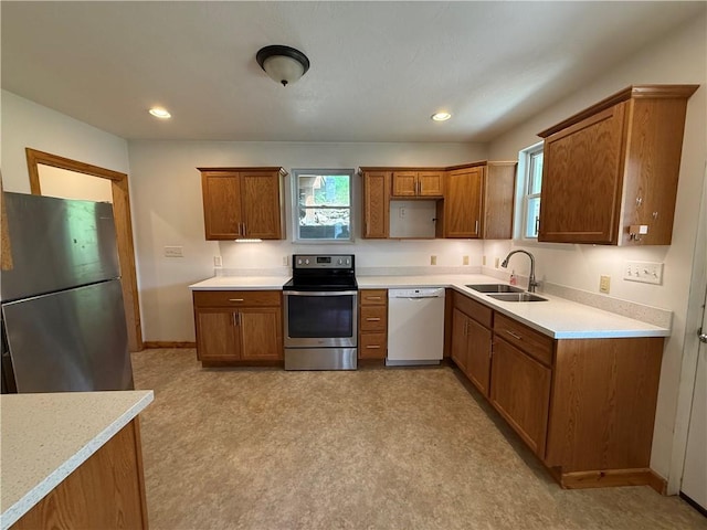 635 Valley St, Oakmont, PA 15139 - kitchen with appliances with stainless steel finishes, a sink, brown cabinets, light countertops, and recessed lighting