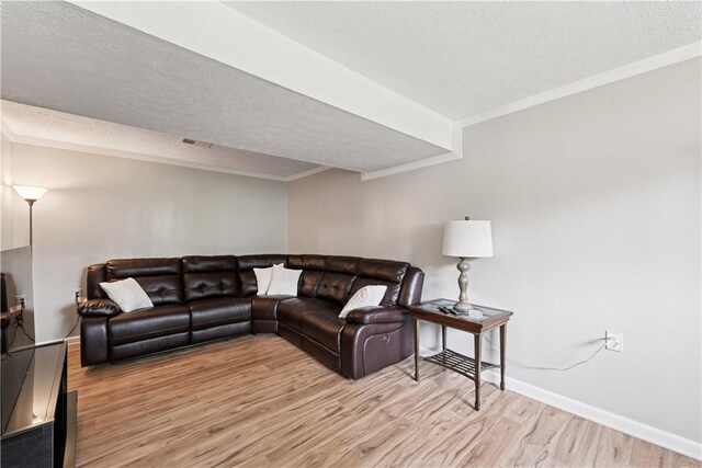 102 Castle Hill Rd, Monroeville, PA 15146 - living room featuring wood finished floors, a textured ceiling, ornamental molding, and baseboards