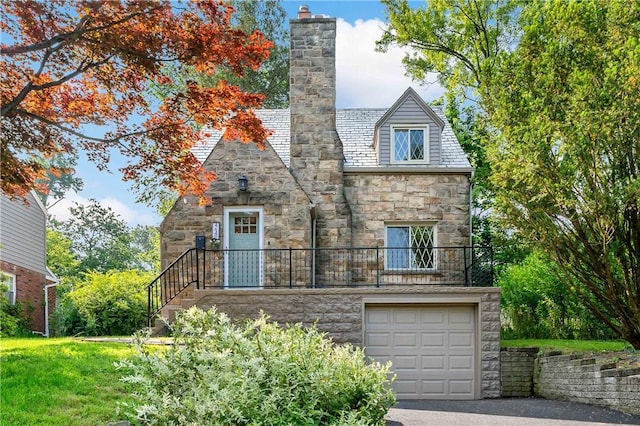 4649 Rolling Hills Rd, Whitehall, PA 15236 - view of front of house with stone siding, a chimney, driveway, a garage, and a high end roof