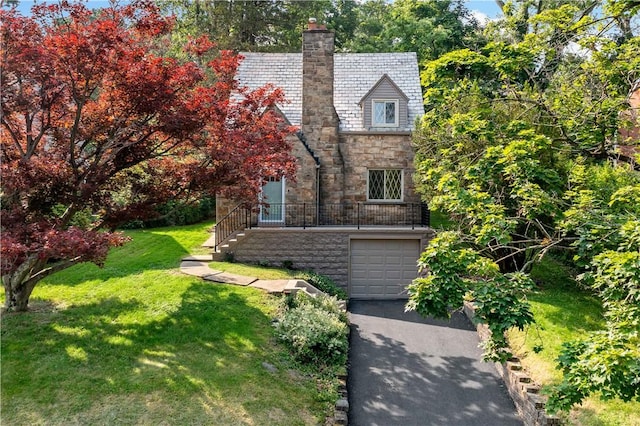4649 Rolling Hills Rd, Whitehall, PA 15236 - view of front of property featuring stone siding, an attached garage, a chimney, driveway, and a front lawn
