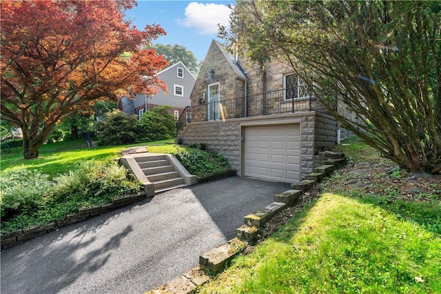 4649 Rolling Hills Rd, Whitehall, PA 15236 - view of front of home with stone siding, stairs, a garage, asphalt driveway, and a front yard