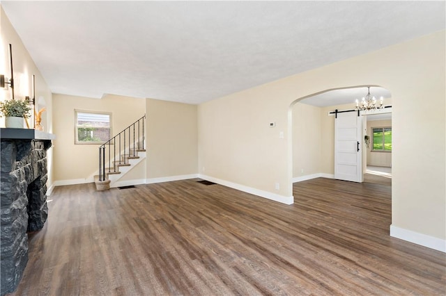 4649 Rolling Hills Rd, Whitehall, PA 15236 - unfurnished living room with wood finished floors, arched walkways, stairs, and baseboards
