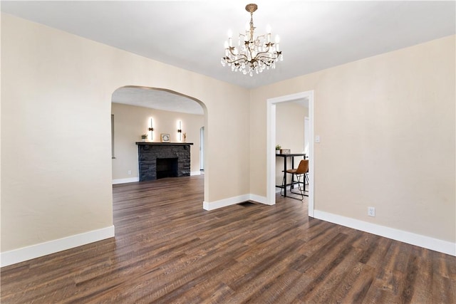 4649 Rolling Hills Rd, Whitehall, PA 15236 - unfurnished room with arched walkways, dark wood-type flooring, baseboards, and a chandelier